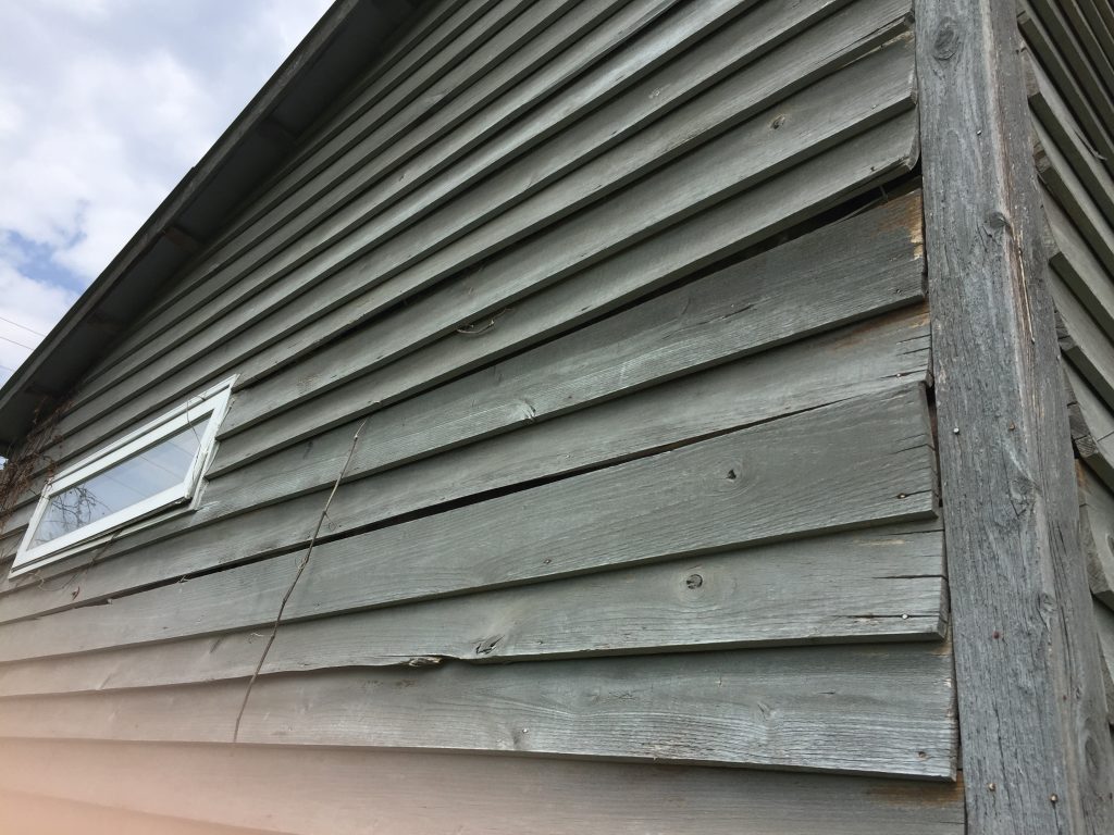 Gaps and warps of bathhouse siding. Gaps and warps of bathhouse siding.